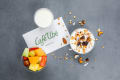 Granola, yoghurt and fruit salad pots with a Cafu00e9 Ubu00e9 napkin