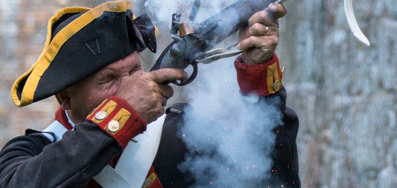 Elizabeth Castle Living History Gunner fires shot