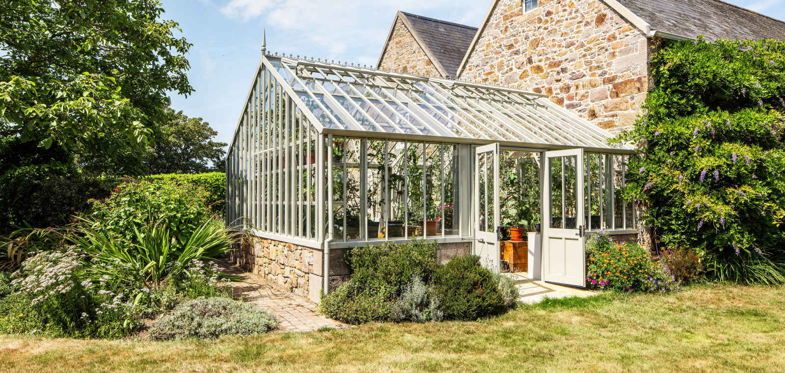 Greenhouse and granite building which houses Gardener's Rest