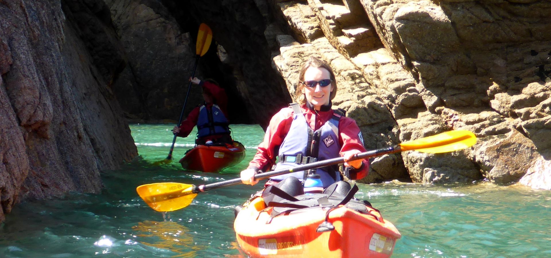 kayaker beneath the cliffs