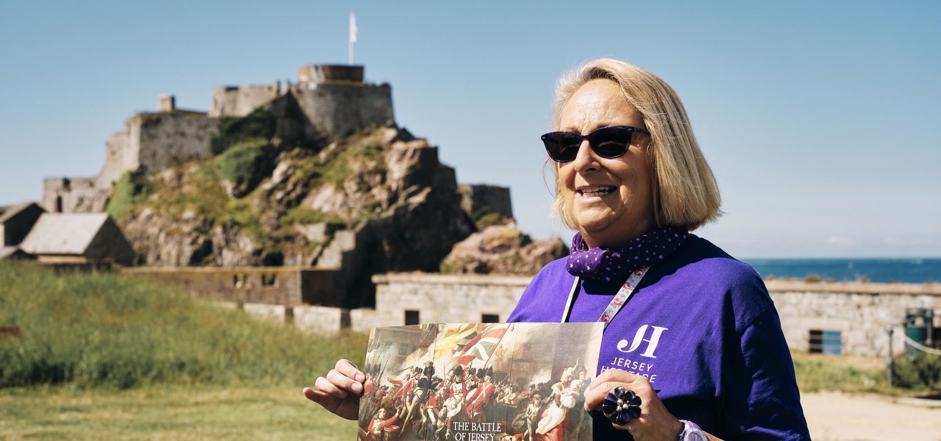 women shows map of the Castle with Castle in background