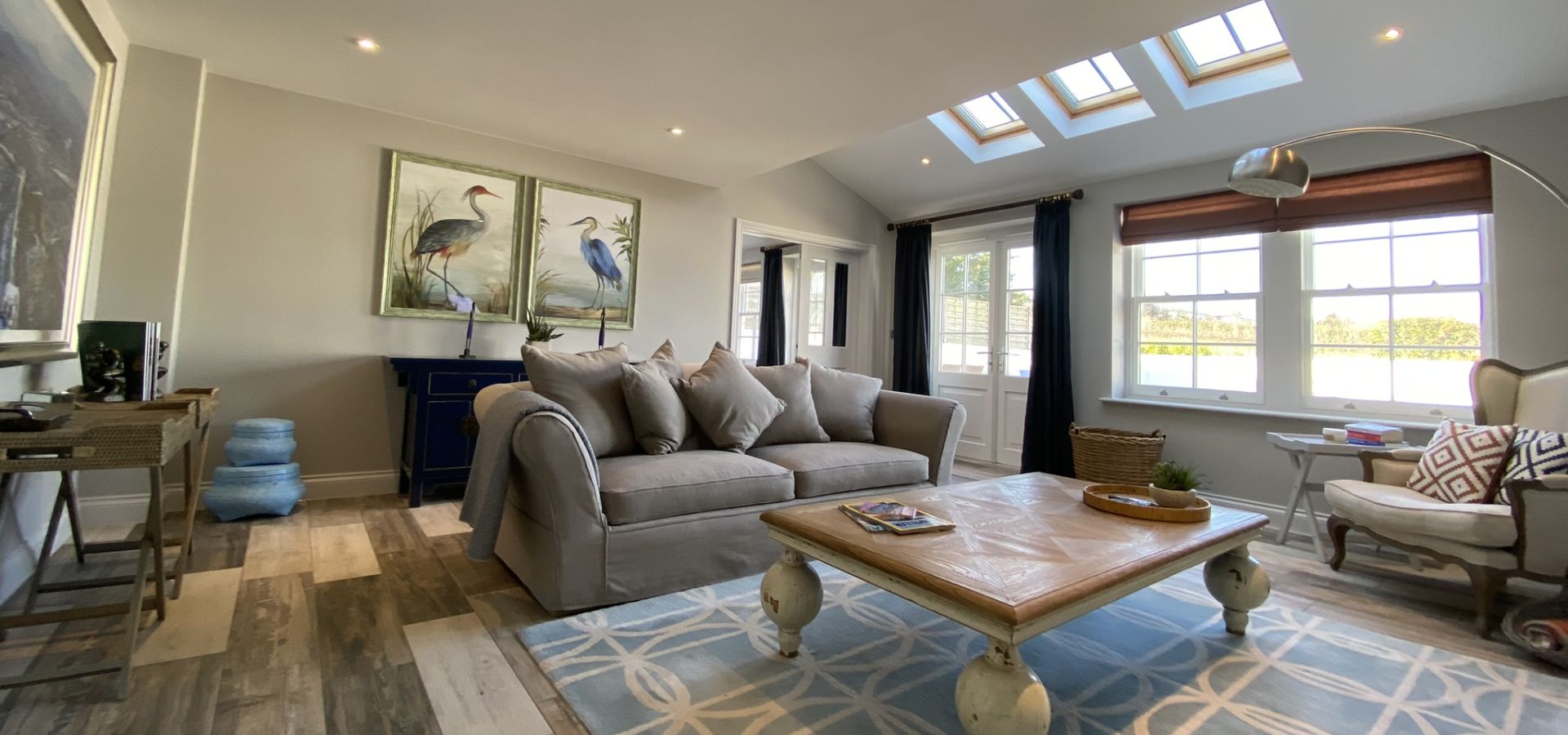 Beautiful spacious living area with doors leading to the kitchen and patio
