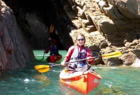 kayaker beneath the cliffs