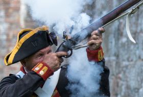 Elizabeth Castle Living History Gunner fires shot