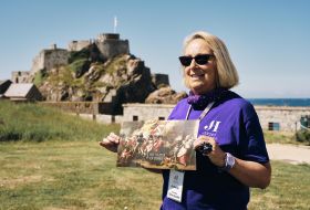 women shows map of the Castle with Castle in background