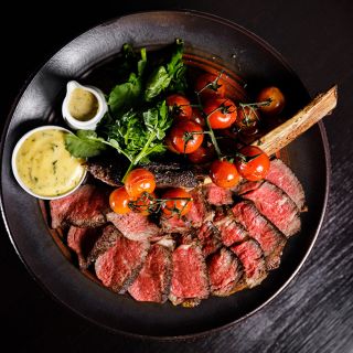 Tomahawk steak with grilled tomatoes