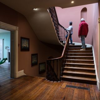 Couple walk up the stairs in Victorian House