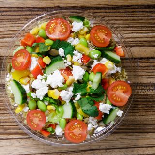 A salad made with tomatoes, cucumber, and feta