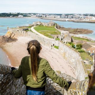 Girl looks at view from the top of the castle