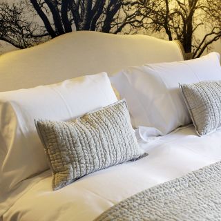 A king-size bed with decorative pillows