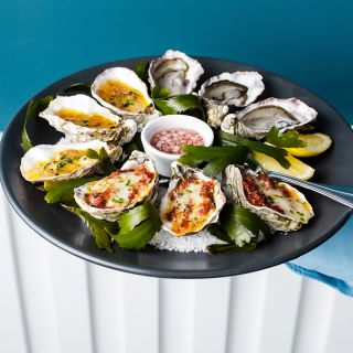 Plate with rock salt and seaweed, showing several different oyster variations