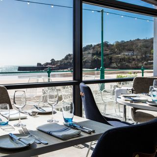 A floor-to-ceiling window with views across St Brelade