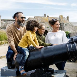 Family look at cannons at the castle