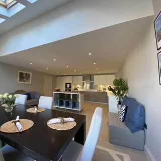 Open plan kitchen, dining area with doors leading to living room