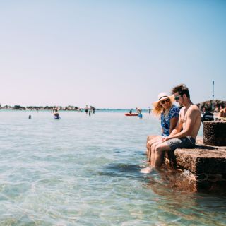 Couple dipping their feet at Green Island
