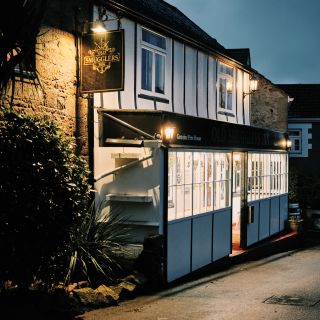 The Smugglers Inn at Ouaisnu00e9 Bay at nighttime