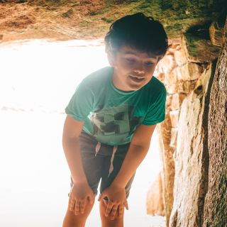 Boy enters passage grave at La Hougue Bie