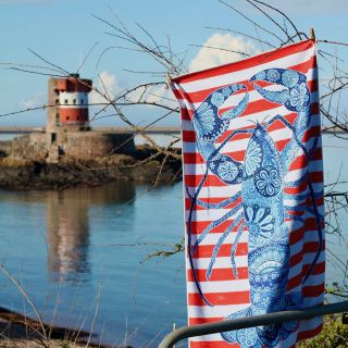 Archirondel beach towel pictured hanging overlooking Archirondel bay and the tower that inspired it