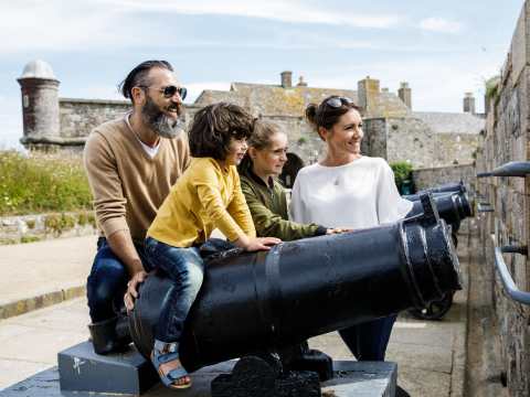 Family look at cannons at the castle