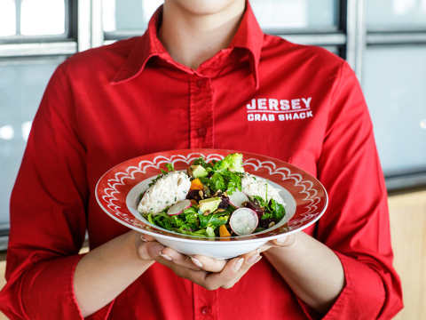 Jersey Crab Shack team member holding a salad