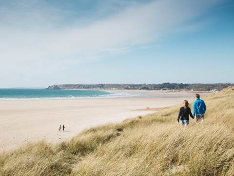 People walking along the grassland above St. Ouen's Bay