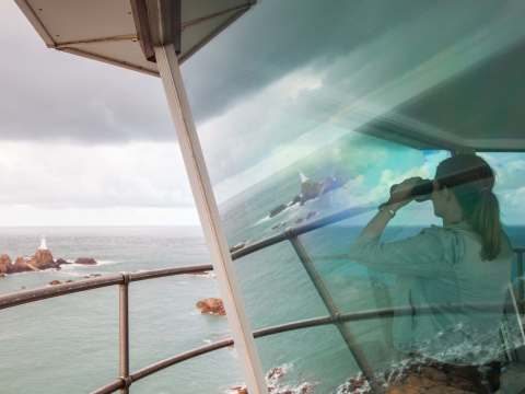 Woman looks at lighhouse from Radio Tower