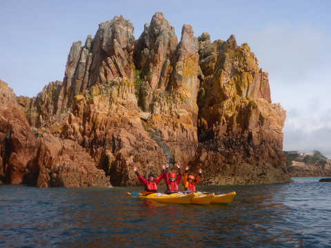 3 kayakers beneath the cliffs at Beauport