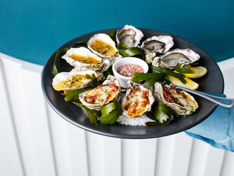 Plate with rock salt and seaweed, showing several different oyster variations