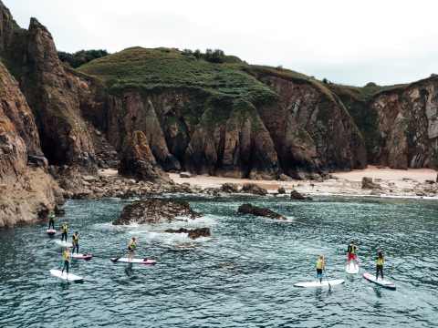 Kayakers exploring the surrounding rockpools and gullies at Gru00e8ve de Lecq