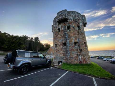 One of the tour 4x4 in front of a ww2 tower