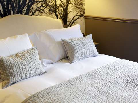 A king-size bed with decorative pillows