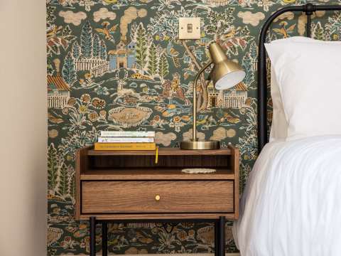 Books, wallpaper and bed close up