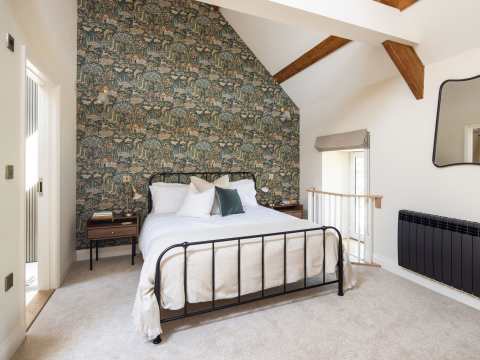 Guest bedroom with king size bed and gorgeous 'Home Park' wallpaper