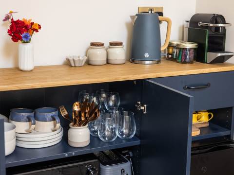 Refreshment station showing kettle, coffee machine, crockery, microwave and toaster