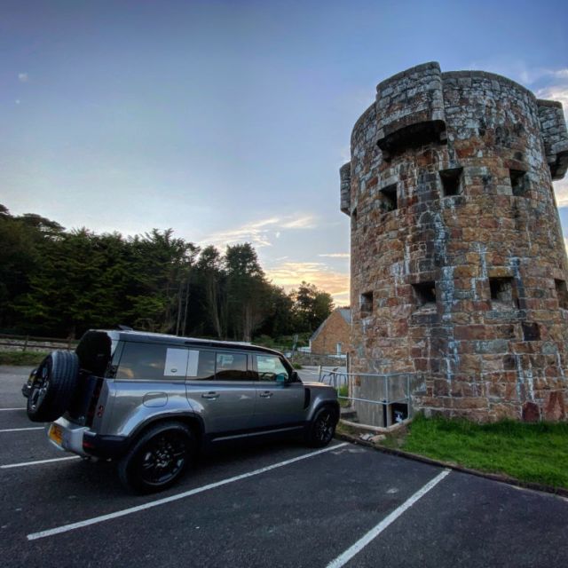 One of the tour 4x4 in front of a ww2 tower