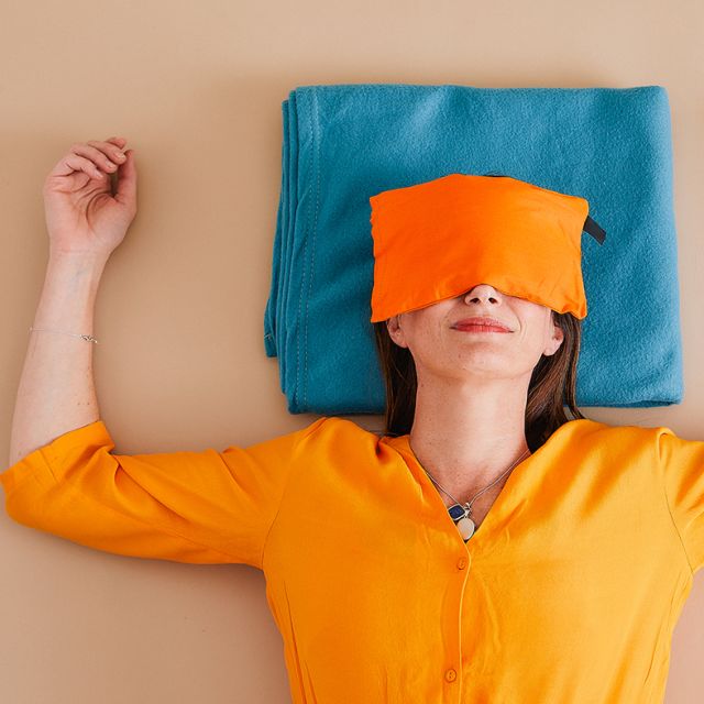 Carla Yoga in floor with eye mask over eyes meditating