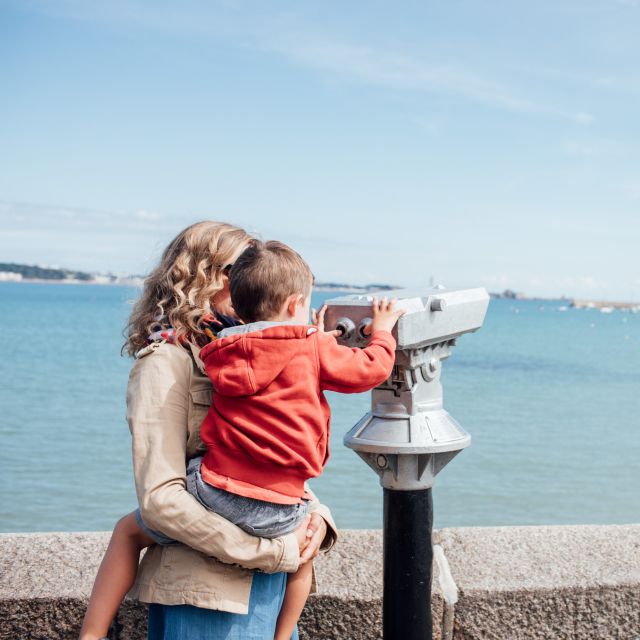 Mother and child look through binoculars at St. Aubin