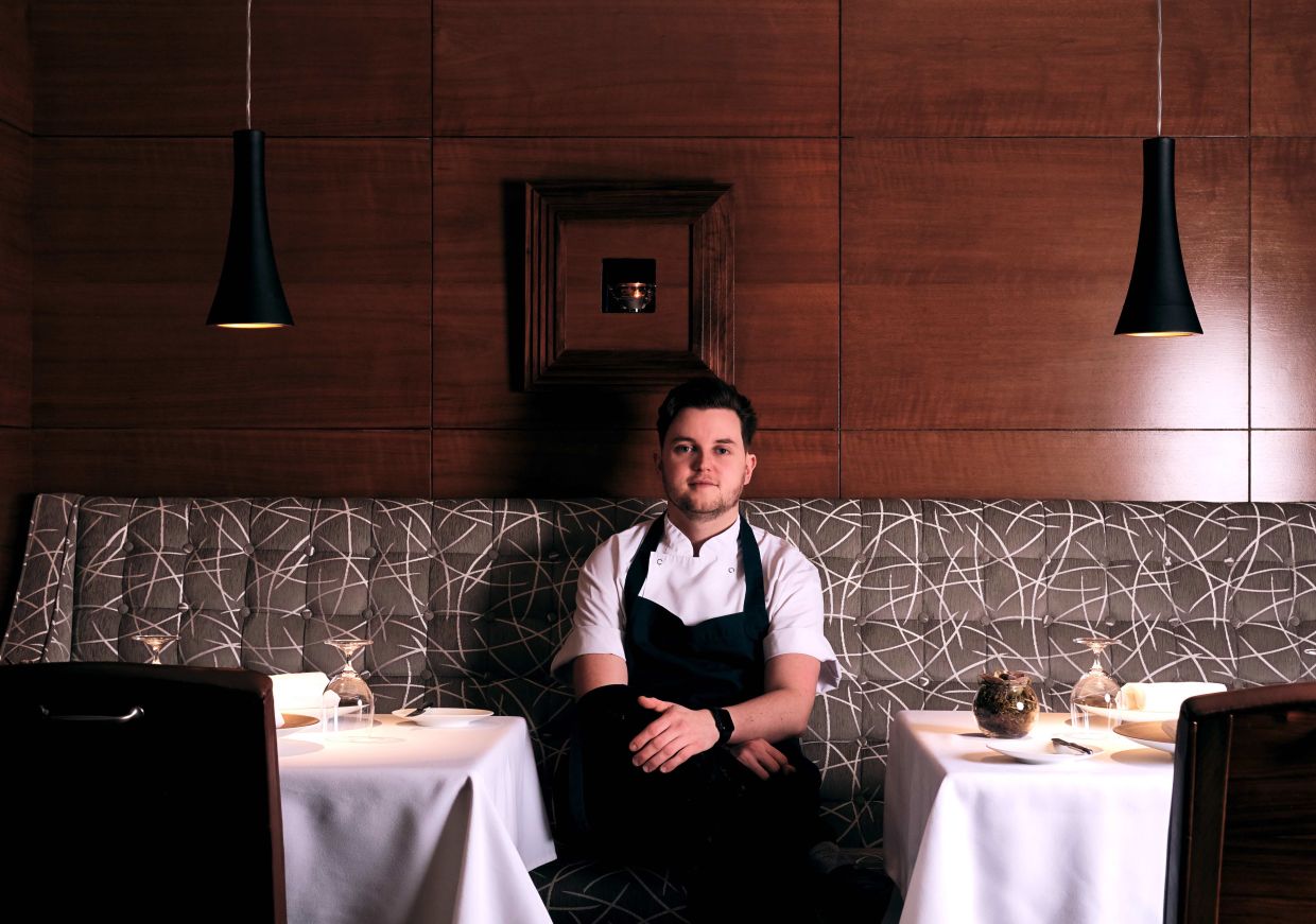 Callum Graham sat in restaurant booth