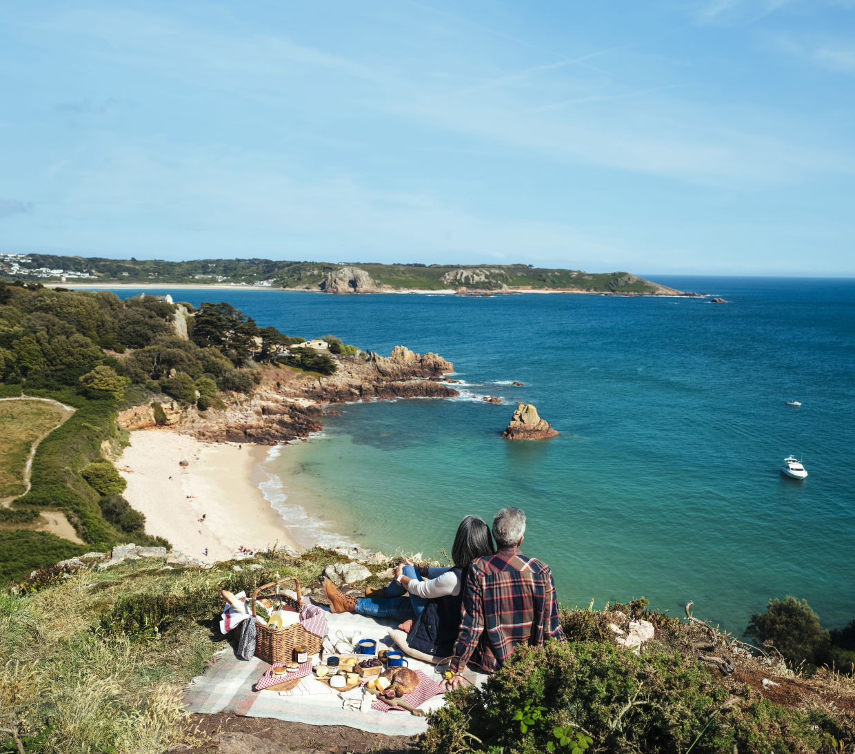 A couple picnicking above Beauport Bay