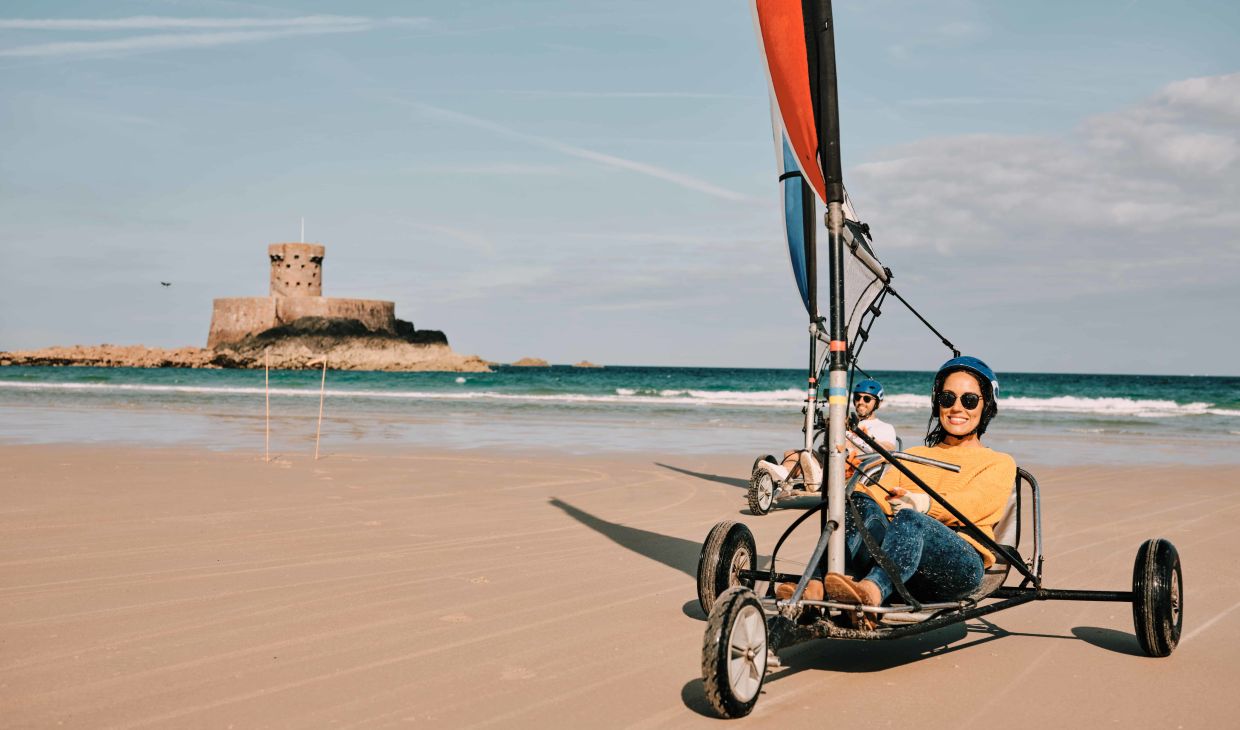 person riding a blokart on St. Ouens beach