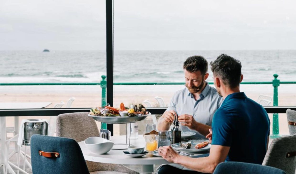 People sat al fresco eating fresh seafood