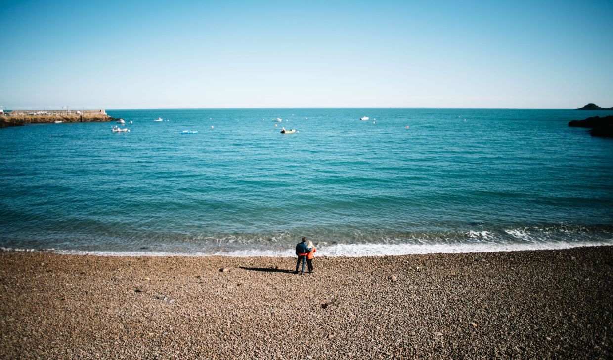 Couple standing at Bouley Bay, Jersey