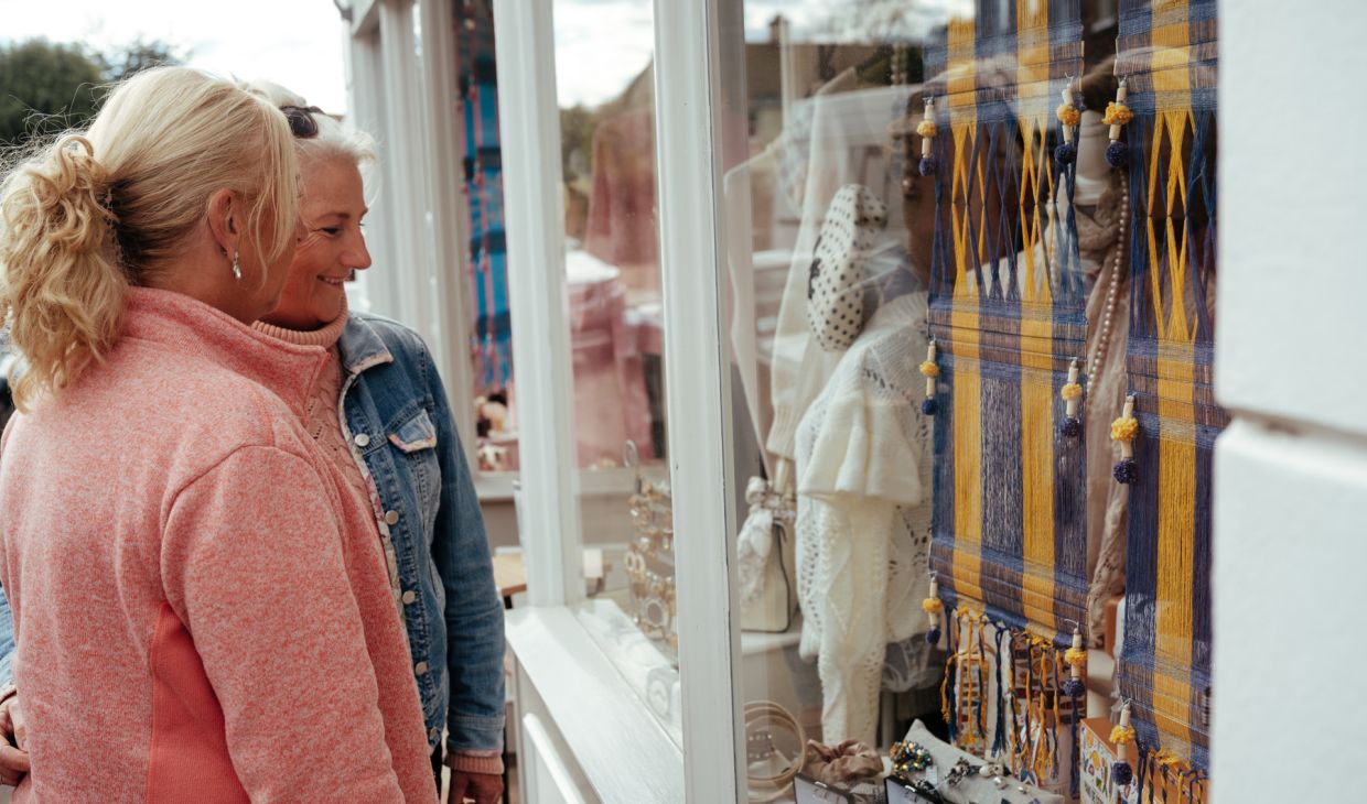 Two women looking into a shop window