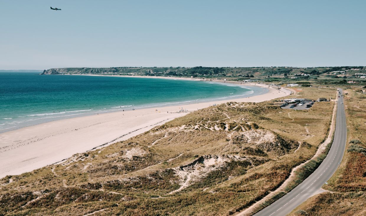 Long road running alongside a beach