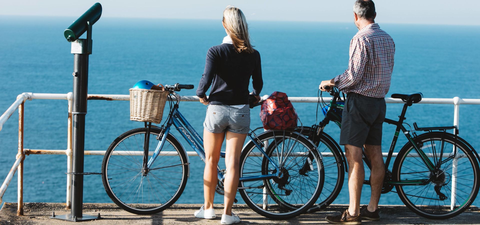 Couple cycling on the coast