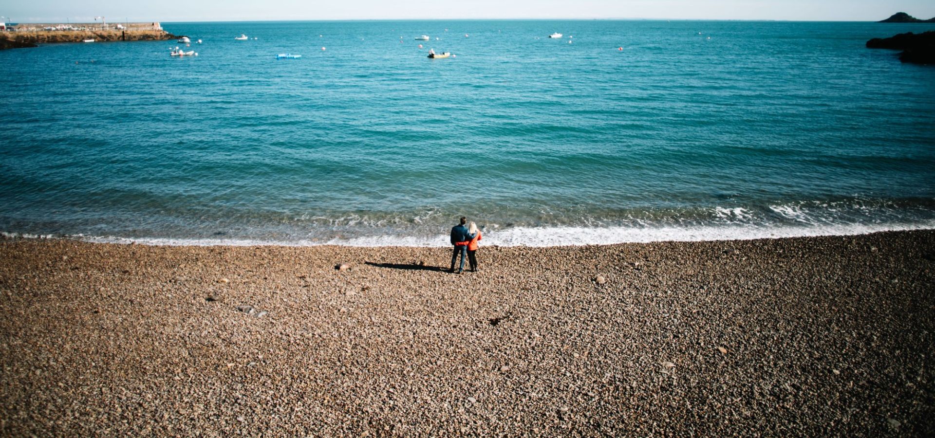 Couple standing at Bouley Bay, Jersey