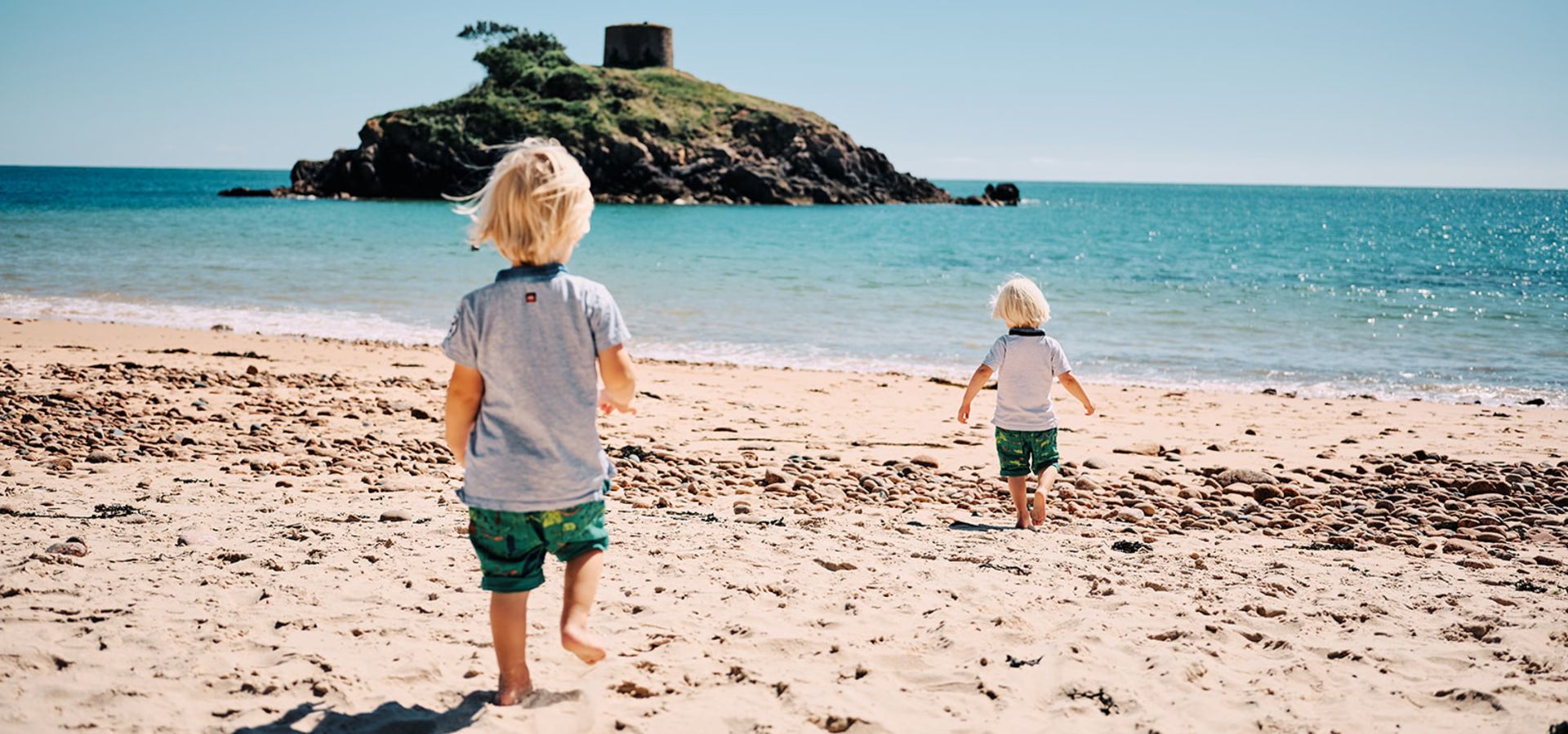 Two little boys playing on Portelet beach