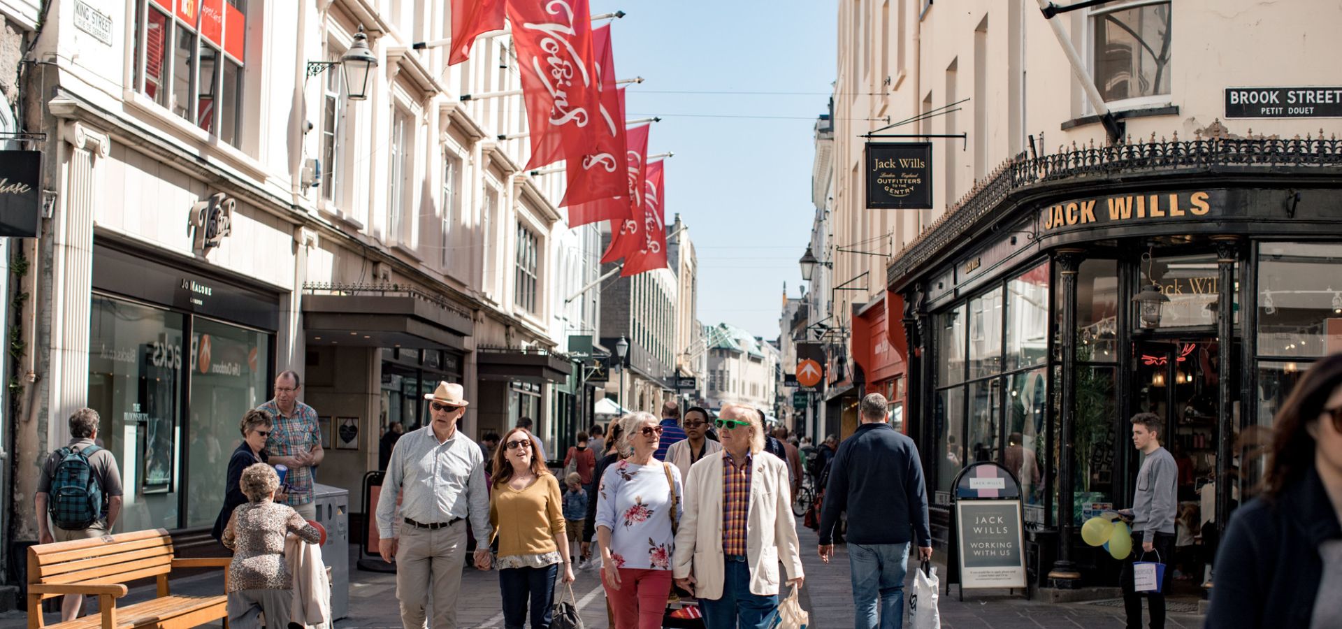 A group of people shopping in St. Helier outside Voisin