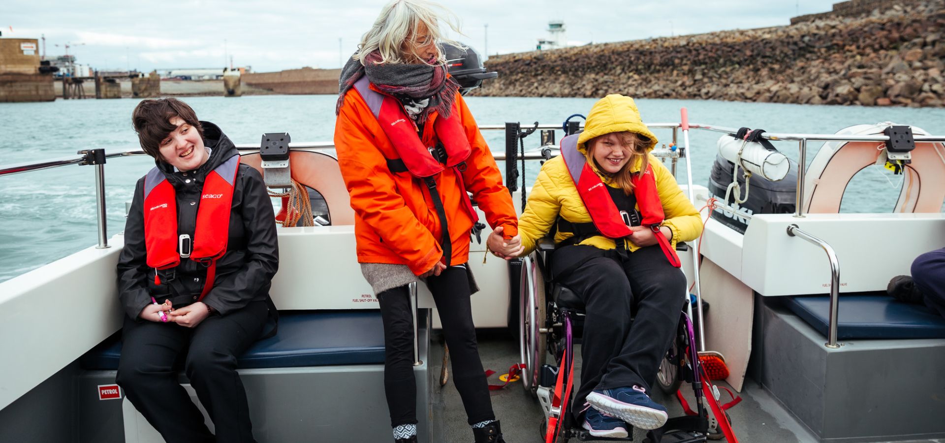 Young wheelchair user on a Wet Wheels Boat trip with carer