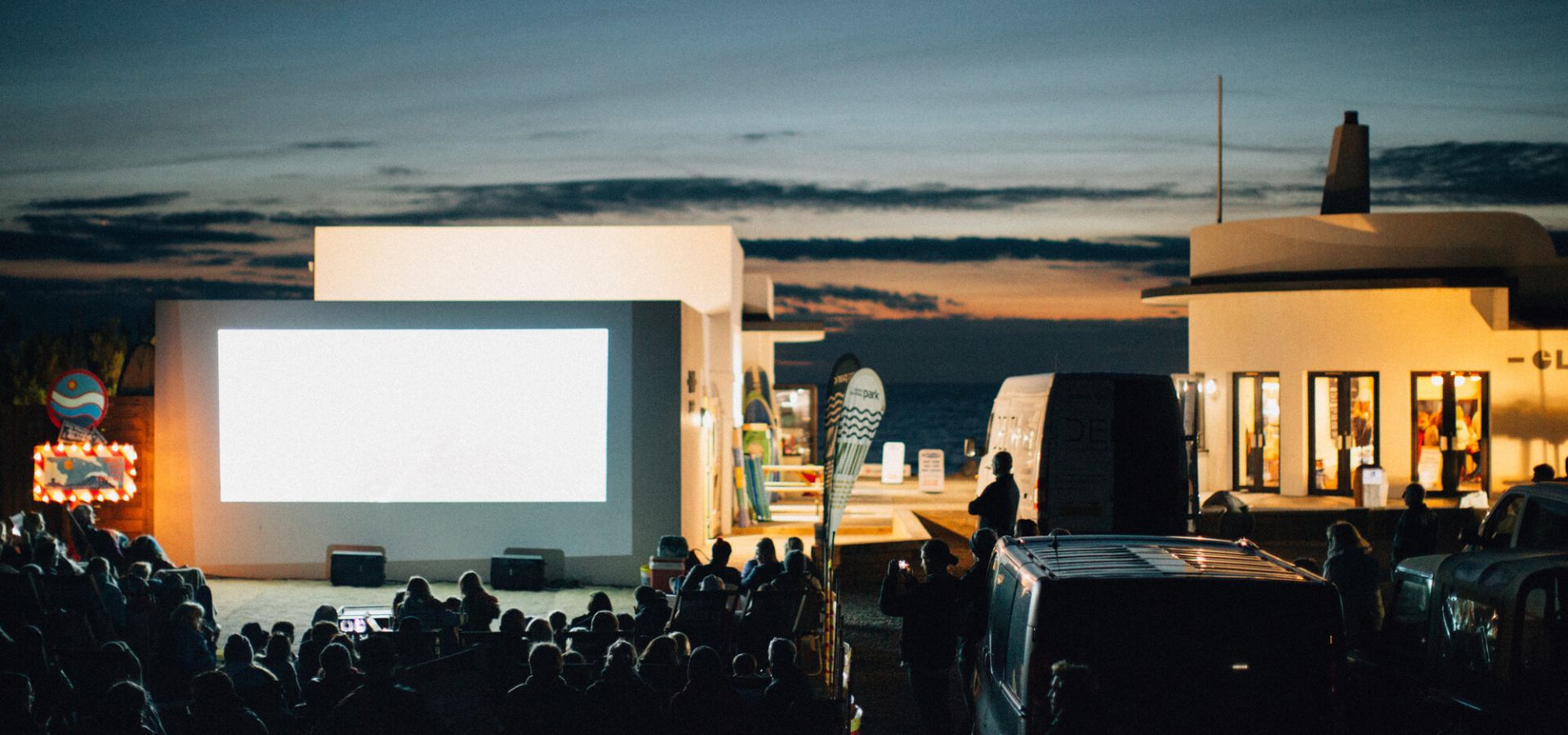 Outdoor film screening in the evening by the beach